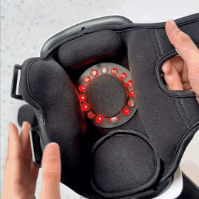 Person demonstrating the Ember knee pain relief device. Showing infrared heating elements and soft padding